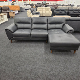 Penrith 3 Seater Leather Sofa with Chaise in black leather, angled view showing the tufted chaise seat and timber legs, at The A2Z Furniture showroom
