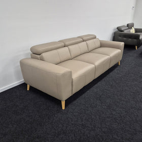 Percy 3 Seater Leather Lounge in Khaki viewed from a rear angle showing the wide square arms, three seat cushions and tapered timber legs, at The A2Z Furniture showroom