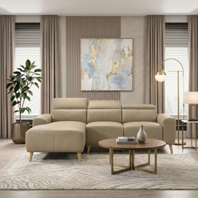 Percy 3 Seater Leather Lounge with Chaise in beige leather, set in a modern living room with neutral tones, featuring a round wooden coffee table and contemporary decor.