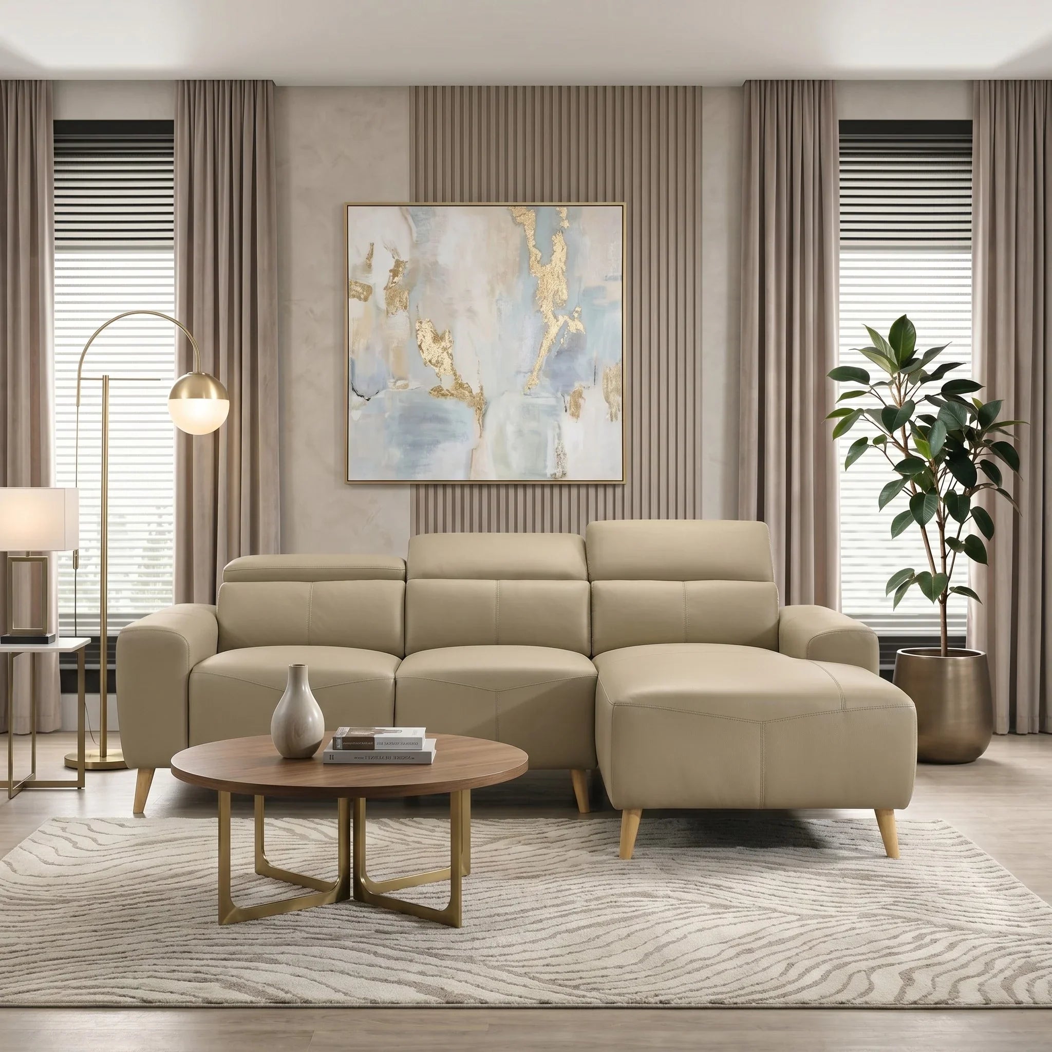 Percy 3 Seater Leather Lounge with Chaise in beige, featuring sleek wooden legs, placed in a modern living room with neutral tones, a round coffee table, artwork, and tall windows with curtains.