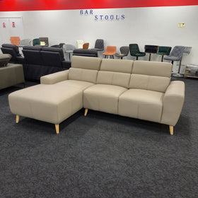 Percy 3 seater leather lounge with chaise in khaki, angled view with the headrests folded down, in The A2Z Furniture showroom