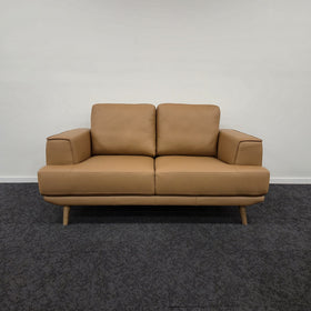 Picasso 2 Seater Leather Lounge in Orange leather, front view showing two seat cushions, two back cushions and wide padded armrests, on display in The A2Z Furniture showroom.