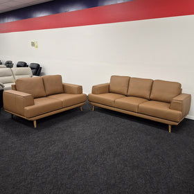 Picasso 3+2 Orange Leather Lounge Set, wider showroom view of the 2 seater and 3 seater side by side, showing the relative size of both pieces in The A2Z Furniture showroom.