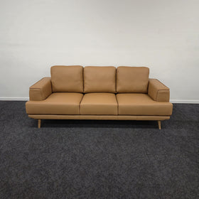 Picasso 3 Seater Leather Lounge in Orange leather, front view showing three seat cushions, three back cushions and wide padded armrests, on display in The A2Z Furniture showroom.