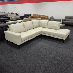 Plenty Leather Chaise Lounge in Light Grey leather, rear three-quarter view showing the low back cushions and black tapered legs, in The A2Z Furniture showroom