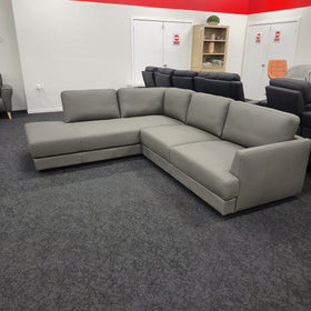 Portsea L-Shaped Corner Leather Sofa in light grey leather viewed from the side, showing the depth of the chaise section, at The A2Z Furniture showroom