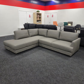 Portsea L-Shaped Corner Leather Sofa in light grey leather, three-quarter view showing the wide track arms, at The A2Z Furniture showroom