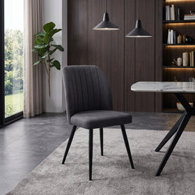 Ritz dining chair — charcoal grey fabric with a vertically channelled curved backrest on black splayed legs