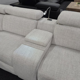 Sandgate Electric Corner Recliner Lounge in light grey fabric with the flexible LED reading light switched on above the centre console, and adjustable headrests raised