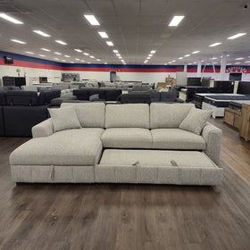 Seaford Corner Sofa Bed in Light Grey with the pull-out bed extended alongside the chaise, showing the full sleeping surface.