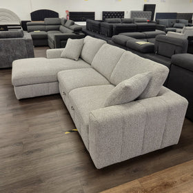 Seaford Corner Sofa Bed in Light Grey viewed from behind at an angle, showing the finished back and arm profile.