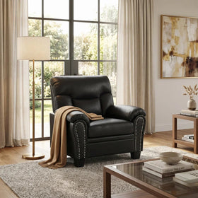 Sebastian PU Leather Arm Chair in black with plush cushioning and studded detailing, placed in a cozy living room setting with natural light and neutral decor.