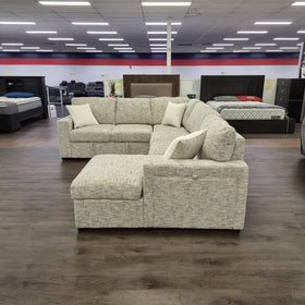 Sherwood U-Shaped Sofa Bed in Beige photographed from the front with the pull-out bed section extended.