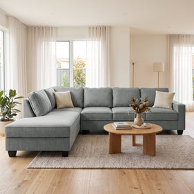 Signature II corner sofa with chaise in dark grey fabric, chaise on the right when sitting, with two throw cushions, styled in a bright living room