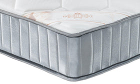 Close-up of the Sleep Rest Bonnell spring mattress corner showing the quilted top and the Dream Rest branded panel above a silver knit-edge border