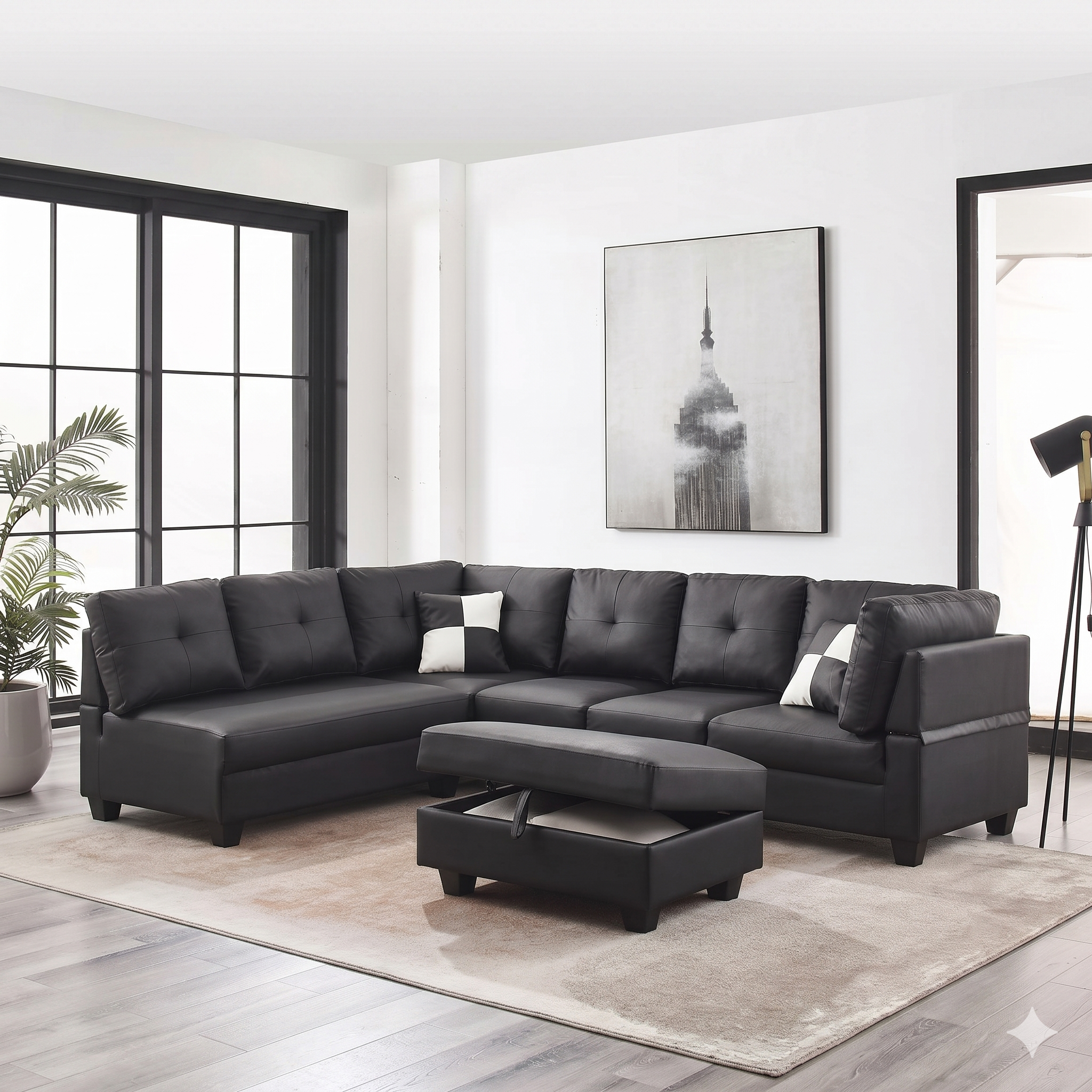 Black sectional sofa in a modern living room with a plant and artwork on the wall.