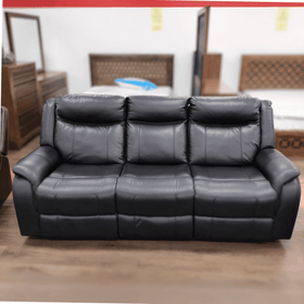 Black leather three seater recliner sofa with plush cushioning in showroom setting