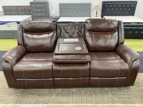 Brown leather recliner sofa with cup holders on display in furniture showroom
