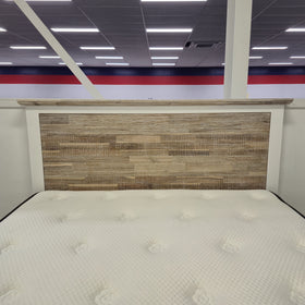 Close-up of the Tasman Storage Bed Frame's brown textured wood-look headboard panel in The A2Z Furniture showroom.