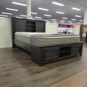 Warwick Bookcase Bed Frame in dark timber finish, angled showroom view at The A2Z Furniture showroom. Mattress shown is not included.